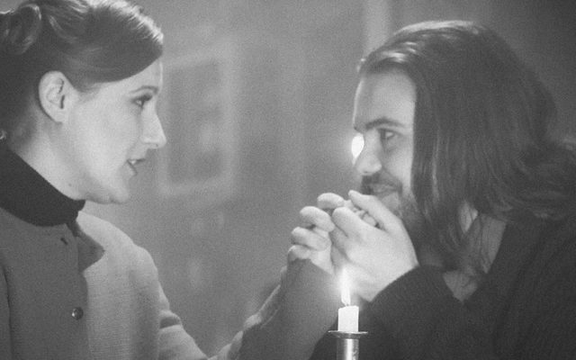 Black and white image of Katie Bird and Thomas Atkins as Mimì and Rodolfo with a candle