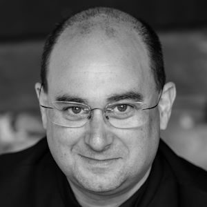 A man wearing glasses without frames.