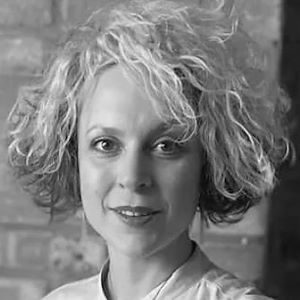 A woman with grey wavy hair.